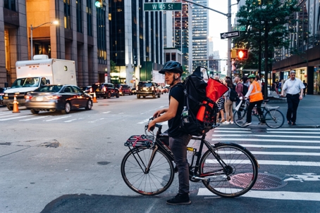 man on bicycle at nyc crosswalk